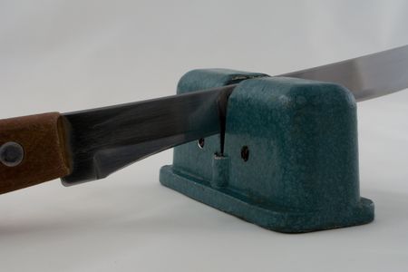 Steel knife sharpener isolated on whiteの写真素材