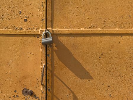 Iron access lock on brown antique doorの写真素材
