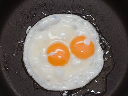 Cooked fried egg food for eating at breakfast mealの写真素材