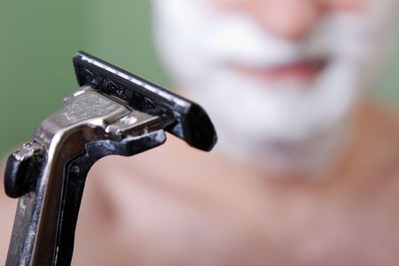 Beauty men with razor shaving blade cutting hairの写真素材
