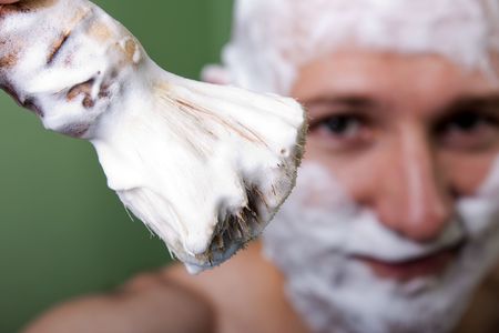 Beauty men with shaving brush cutting hairの写真素材