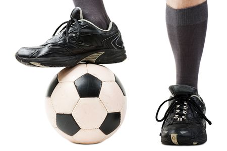 Foot on black white football or soccer sport ballの写真素材