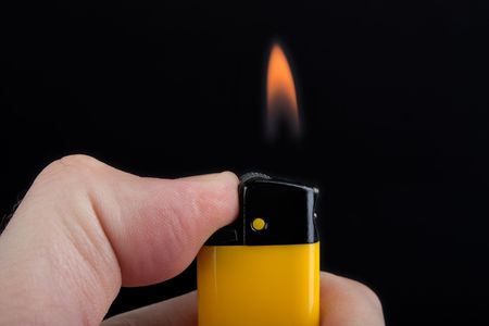 Smoking cigarette gas lighter burning fire flameの写真素材