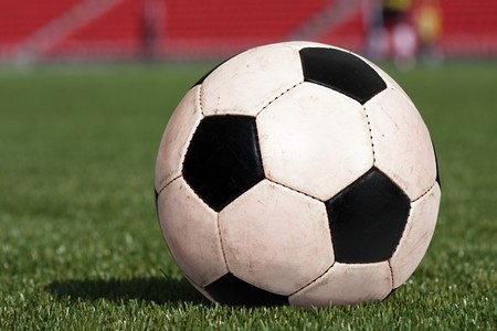 Playing soccer sport ball on green grass fieldの写真素材