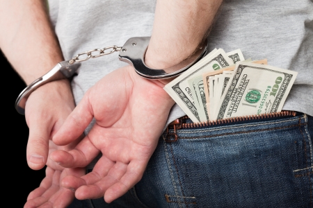 Handcuffs arrests dollar currency crime human handの写真素材