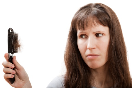 Balding problem women hand holding loss hair combの写真素材