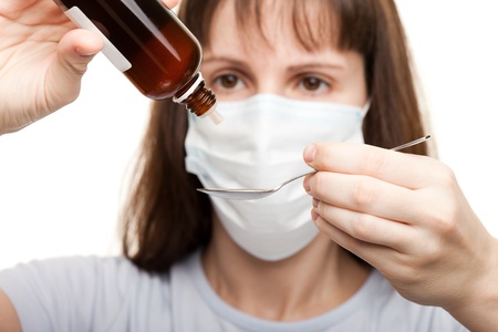 Mask doctor hand holding medicine healthcare syrupの写真素材