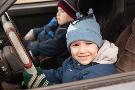 Little smiling child boy driving sport car vehicleの写真素材