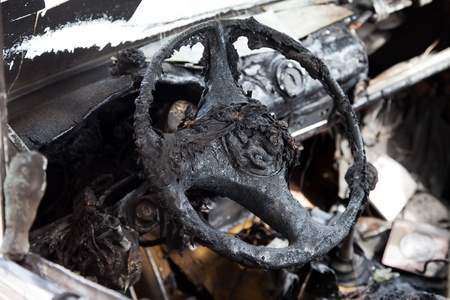 Wreck accident fire burnt wheel car vehicle junkの写真素材