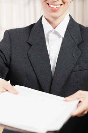 Paperwork - human hand holding business paper fileの写真素材