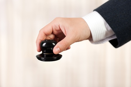 Business men hand hold office paper document stampの写真素材