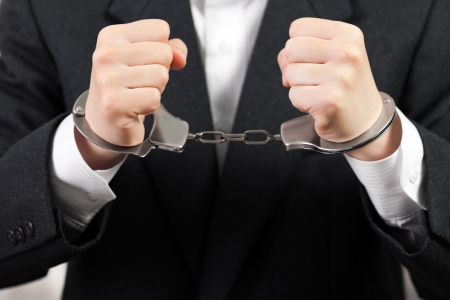 Police steel handcuffs arrests business men handsの写真素材