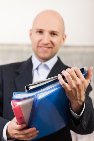 Paperwork - human hand holding business paper fileの写真素材