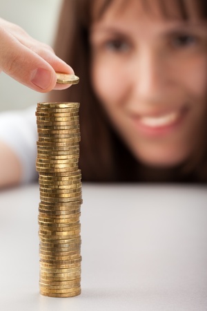 Smiling women hand holding finance currency coinsの写真素材