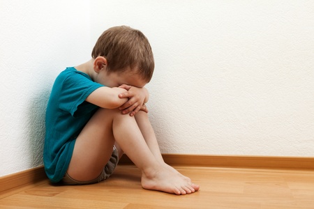 Little child boy wall corner punishment standingの写真素材