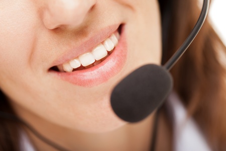 Smiling business woman with headphones or headsetの写真素材