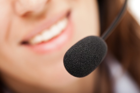 Smiling business woman with headphones or headsetの写真素材