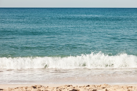 Summer vacations - blue water waves on tropical sea sand beachの写真素材