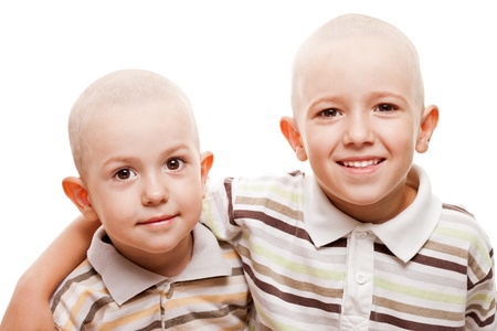Family happiness - two little smiling child boy brothers with bald shaved headsの写真素材