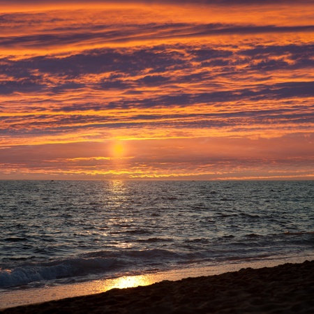 Summer vacations - dramatic cloud sky sunset on blue sea sand beachの写真素材