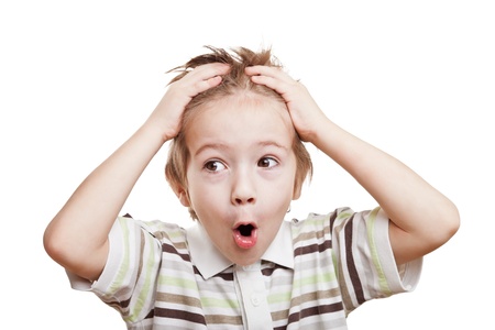 Amazed or surprised child boy hand holding hairs on headの写真素材