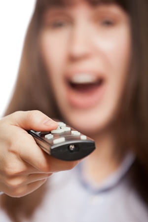 Amazed or surprised woman hand holding television remote control and changing channelの写真素材