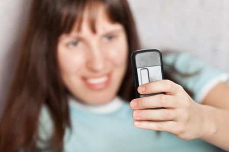 Smiling woman hand holding mobile communication phoneの写真素材
