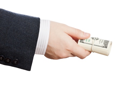 Business man hand holding rolled up paper dollar currencyの写真素材