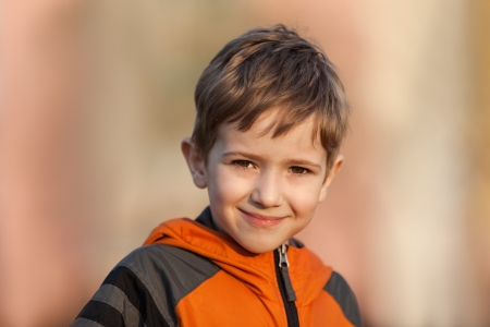 Little cheerful child boy walking outdoor and smiling for happiness and funの写真素材