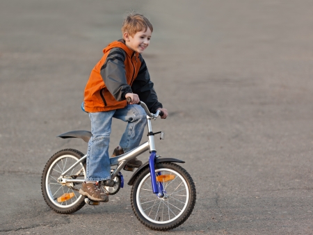 Little smiling child boy cycling sport bicycle outdoorの写真素材