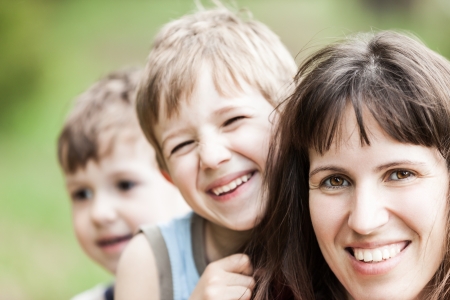 Smiling mother and little sons - family happinessの写真素材