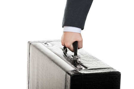Business men in black suit hand holding large travel luggage suitcaseの写真素材