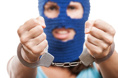 Russian protest movement concept - woman wearing balaclava or mask on head showing handcuffs on hands white isolatedの写真素材