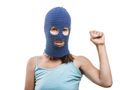 Russian protest movement concept - woman wearing balaclava or mask on head showing raised fist hand gesture white isolatedの写真素材