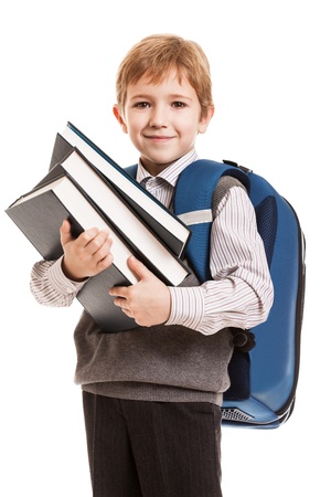 Little smiling child boy with school backpack holding education books in handsの写真素材