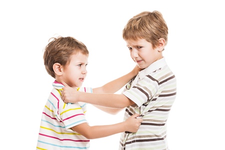 Two little displeased child boy brothers fighting in family conflictの写真素材