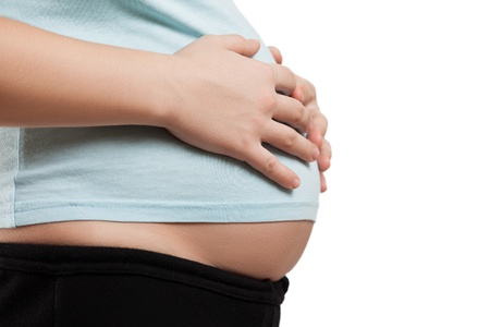 Pregnancy and new life concept - beauty pregnant woman lovely touching or bonding her abdomenの写真素材