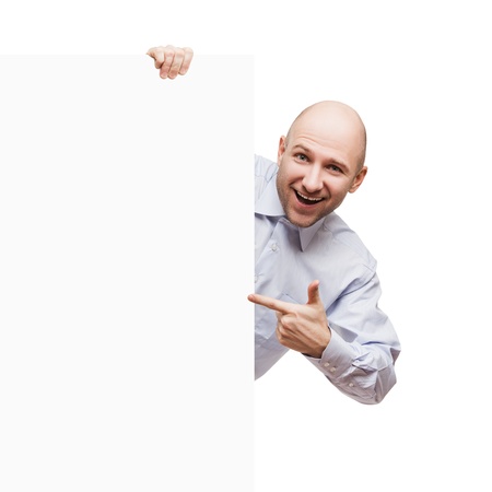 Handsome smiling bald or shaved head man holding blank sign or placard white isolatedの写真素材