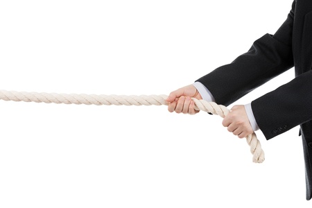 Competition concept - business man in black suit hand holding or pulling rope white isolatedの写真素材
