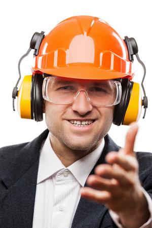Businessman in black suit and safety hardhat helmet gesturing hand greeting or meeting handshake white isolatedの写真素材