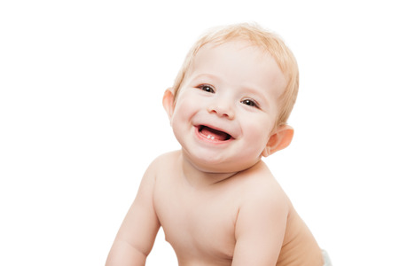 Little cute newborn baby child first milk or temporary teeth smiling face white isolatedの写真素材