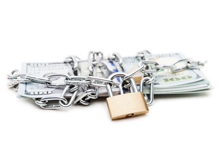 Business safety and finance protection concept - metal chain link with locked padlock on dollar currency money white isolatedの写真素材