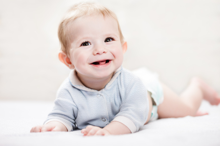 Little cute smiling newborn baby child boy looking faceの写真素材