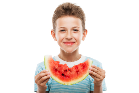 Handsome smiling child boy hand holding red ripe watermelon fruit food slice white isolatedの写真素材