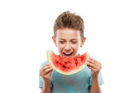 Handsome smiling child boy hand holding red ripe watermelon fruit food slice white isolatedの写真素材
