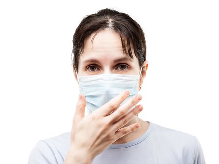 Human population virus, infection, flu disease prevention and industrial exhaust emissions protection concept - beauty woman wearing respiratory protective medical mask hand hiding face white isolatedの写真素材