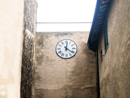 ancient clock in tuscany medieval country placeの写真素材