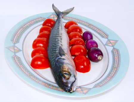 italian bluefish mackerel cooked with cherry tomatoes and red onionsの写真素材