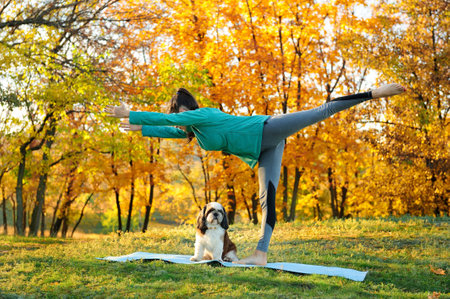 Fit woman practicing one leg stand in open airの写真素材