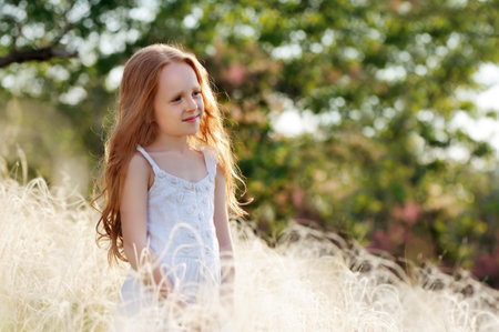 Natural light portrait of a girl at the summer fieldの写真素材